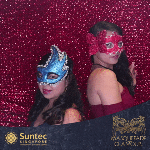 Women with masquerade masks at GIF photo booth