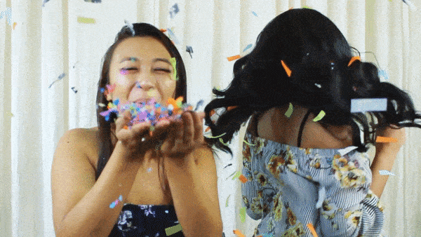 Girl blowing confetti at slow motion video booth