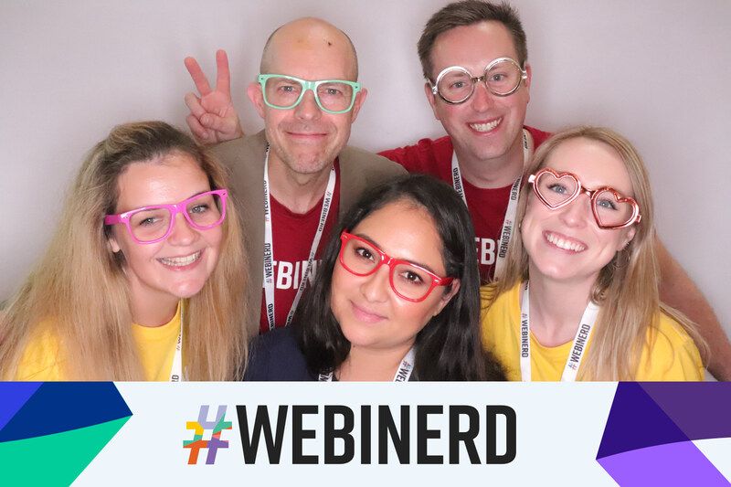 Friends posing at photo booth with nerd glasses at conference show