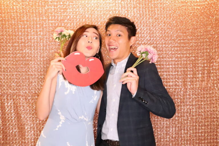 Happy couple posing at wedding photo booth