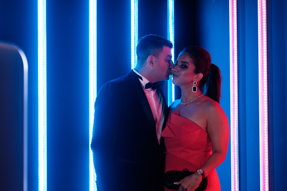 Couples posing in front of wedding photo booth