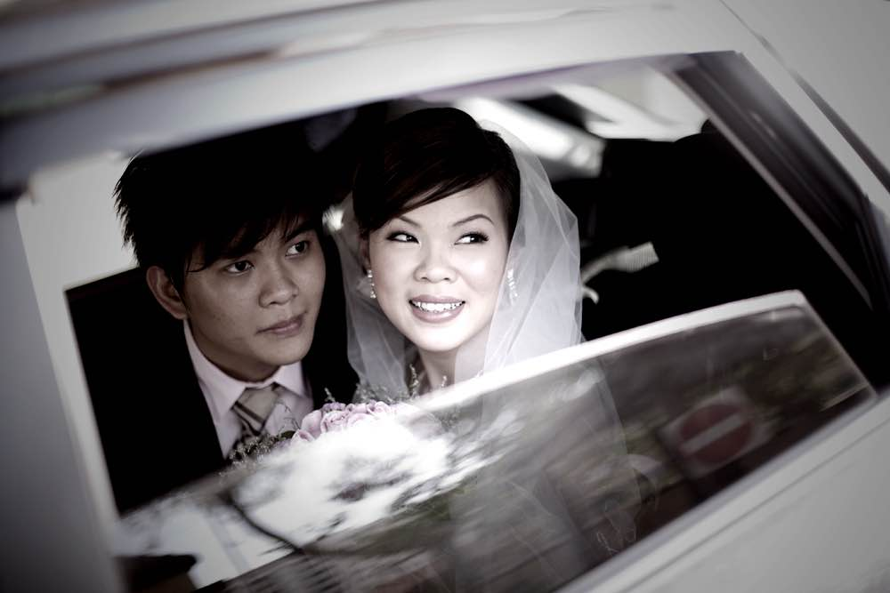 Wedding Couple in their car leaving the wedding ceremony by photographer and photograph