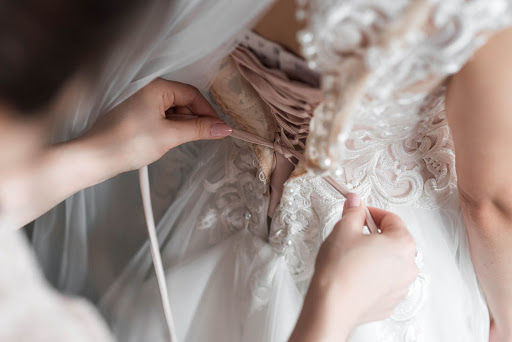 Bride donning on her dress pre-wedding before wedding photoshoot