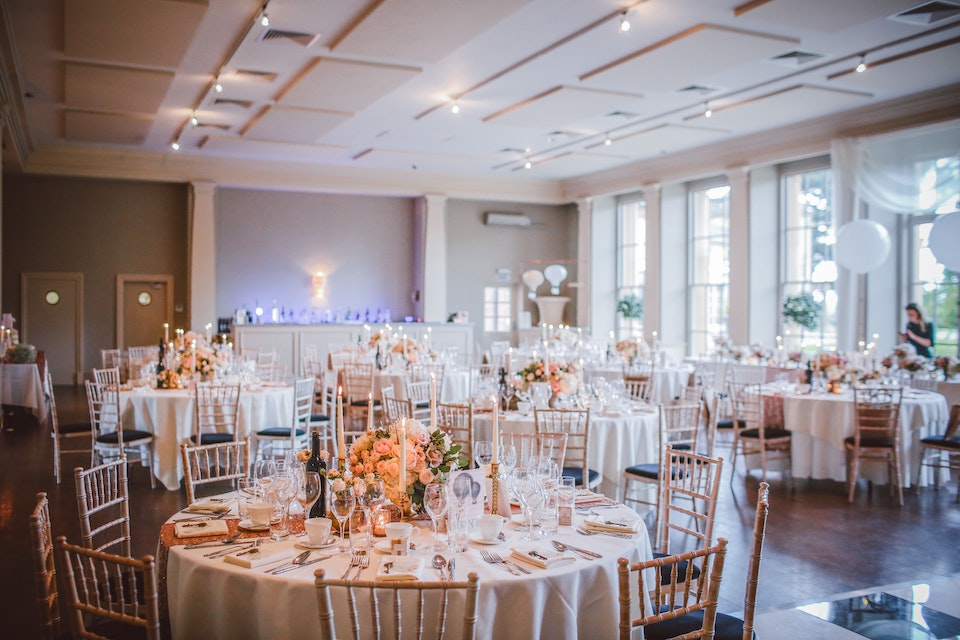 Wide angle shot of ballroom with tables set